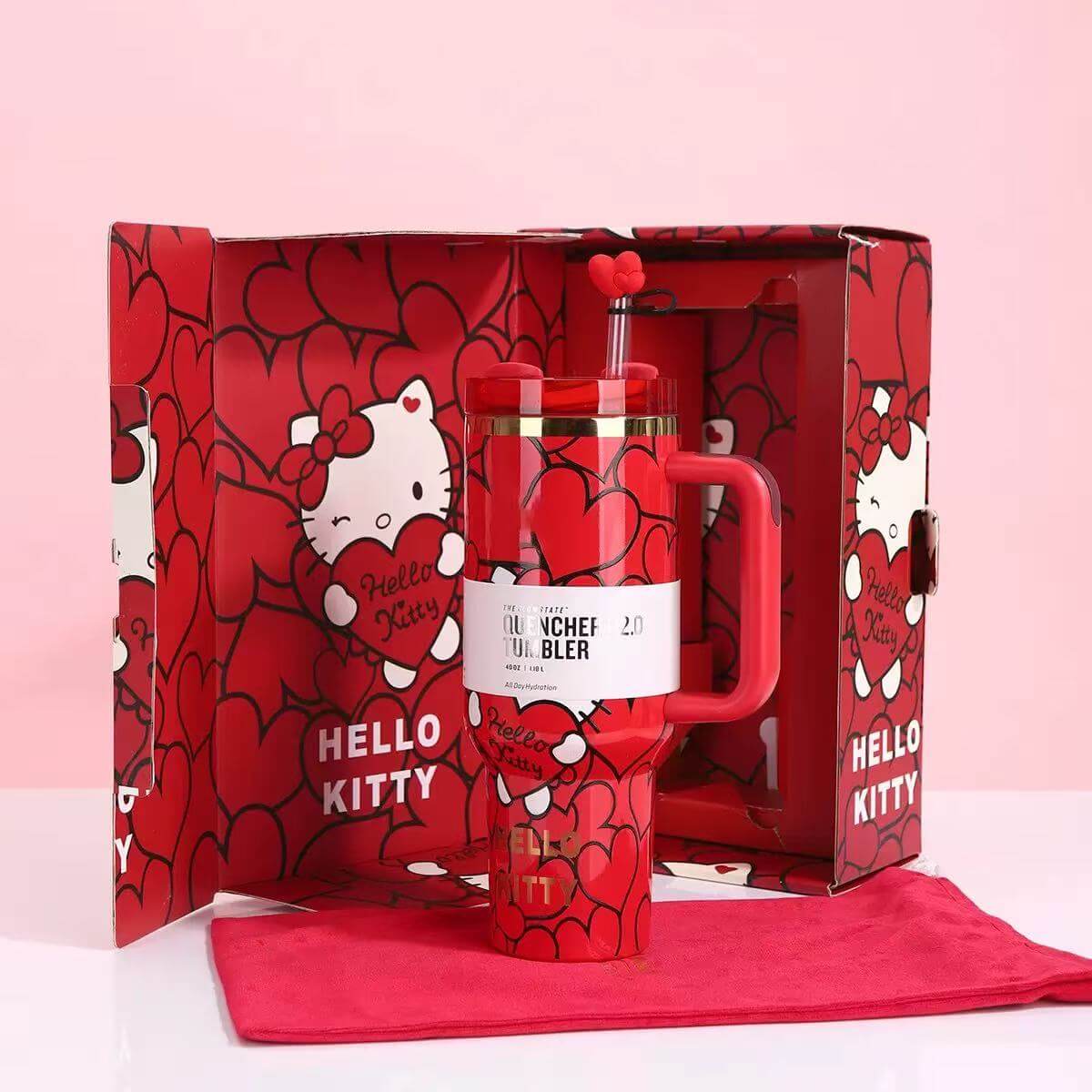 Red 'Hello Kitty' themed lunch set with a lunch bag and bottle in a decorative box on a pink background.