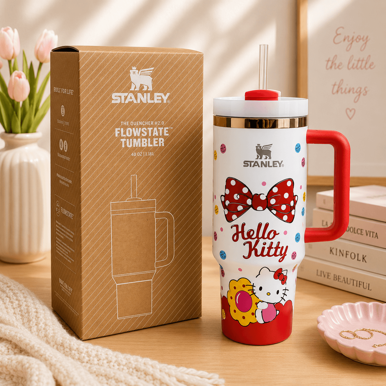 STANLEY Hello Kitty Bow tumbler with red handle, colorful bow artwork, reusable straw, insulated construction, and matching gift-ready packaging.