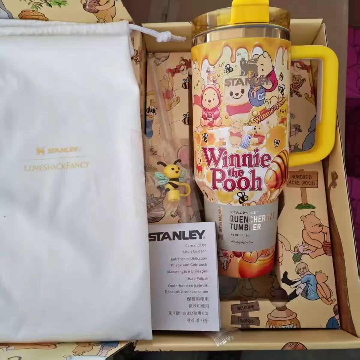 Stanley Winnie the Pooh tumbler with packaging and branded pouch.