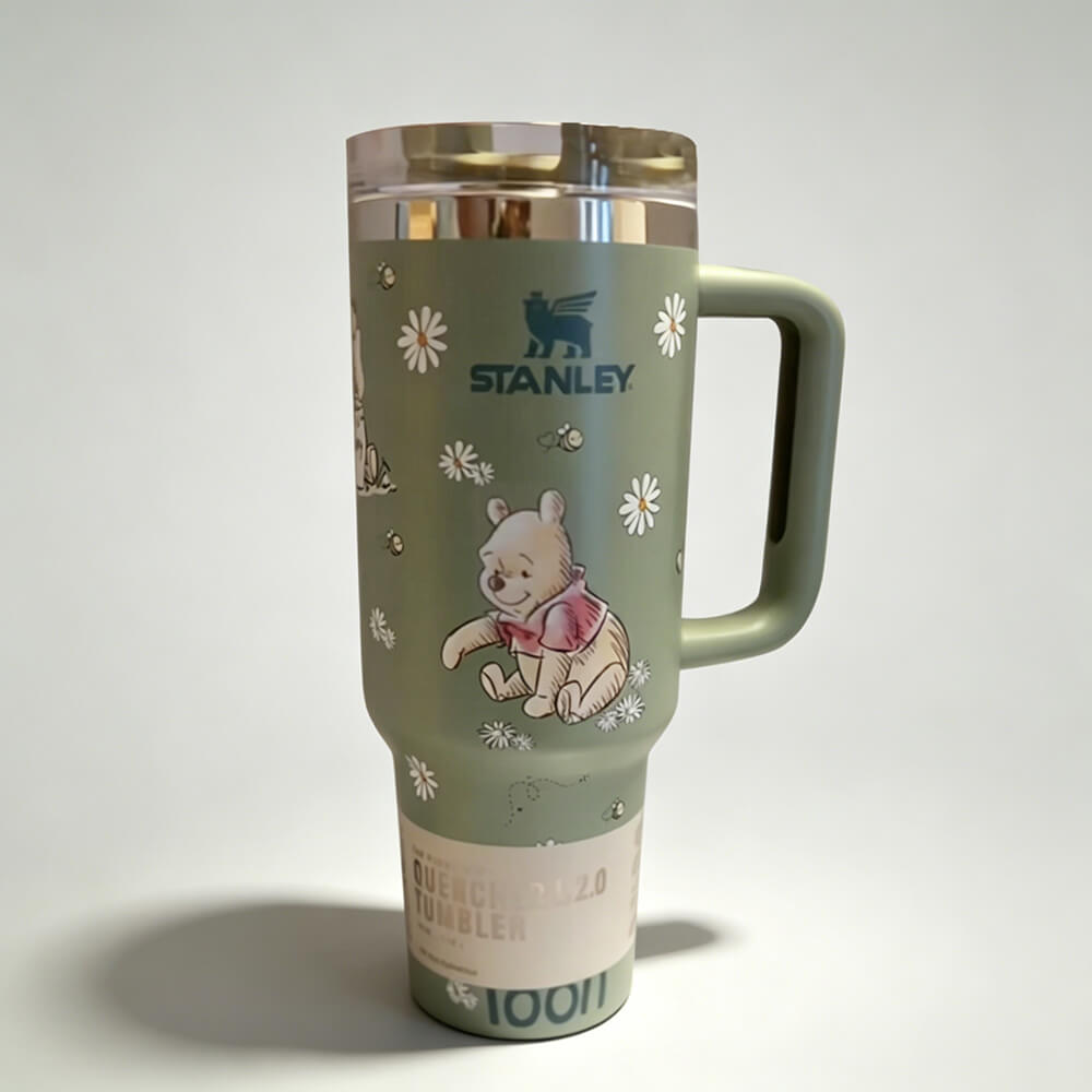 Stanley tumbler with Winnie the Pooh design on a white background