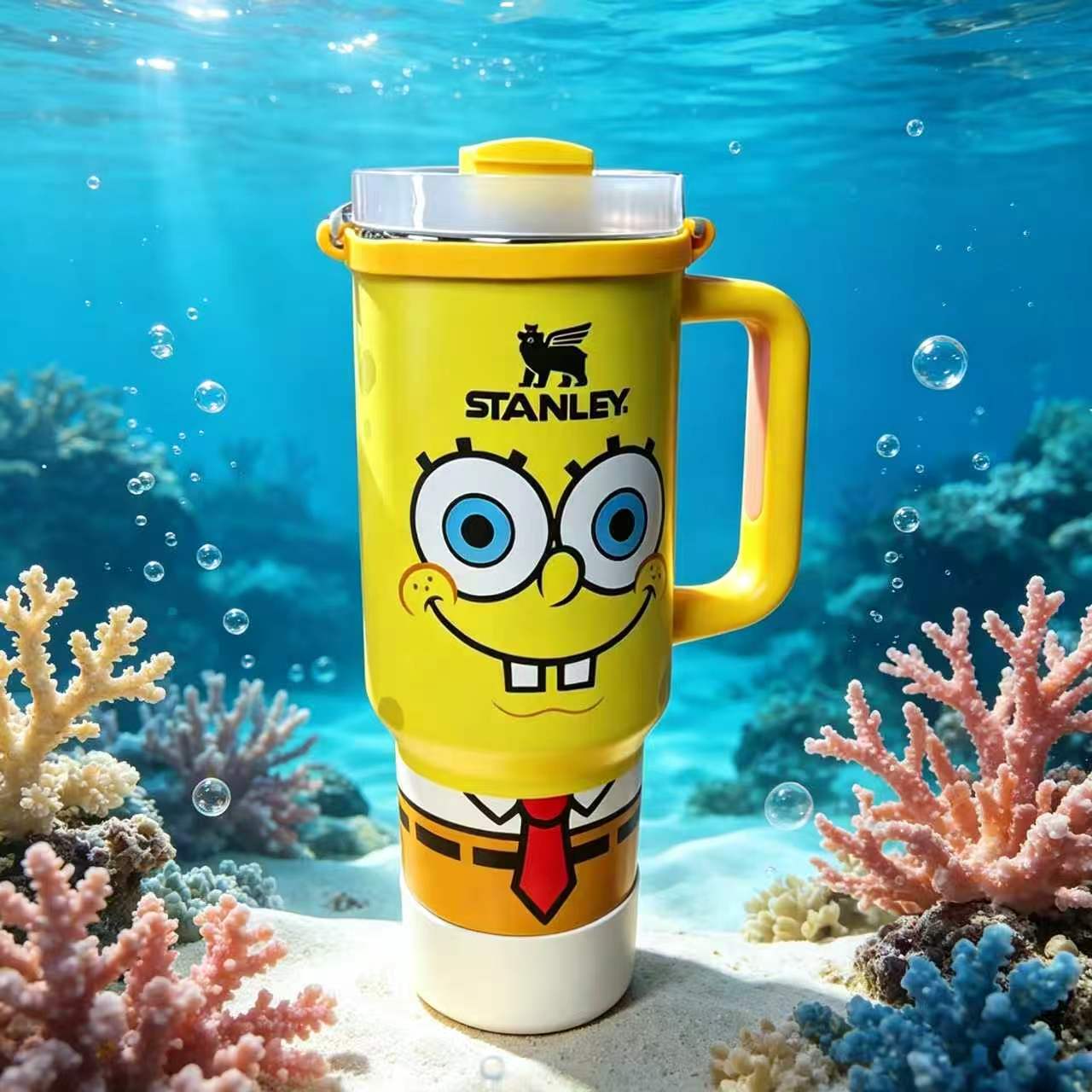 Stanley 40oz insulated tumbler featuring SpongeBob-inspired artwork, underwater ocean background, yellow ergonomic handle, and cartoon-themed design