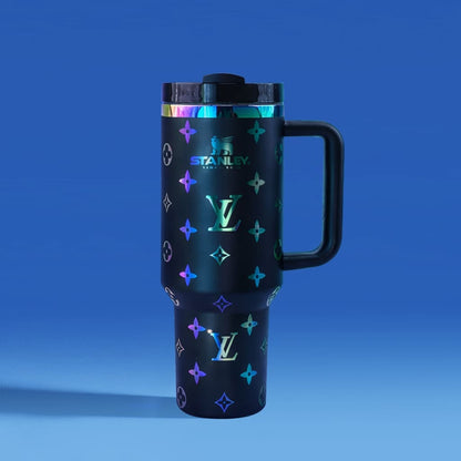 Black Stanley travel mug with colorful pattern on a blue background