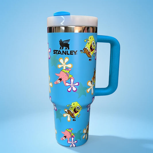 Blue Stanley tumbler with cartoon character design on a light blue background