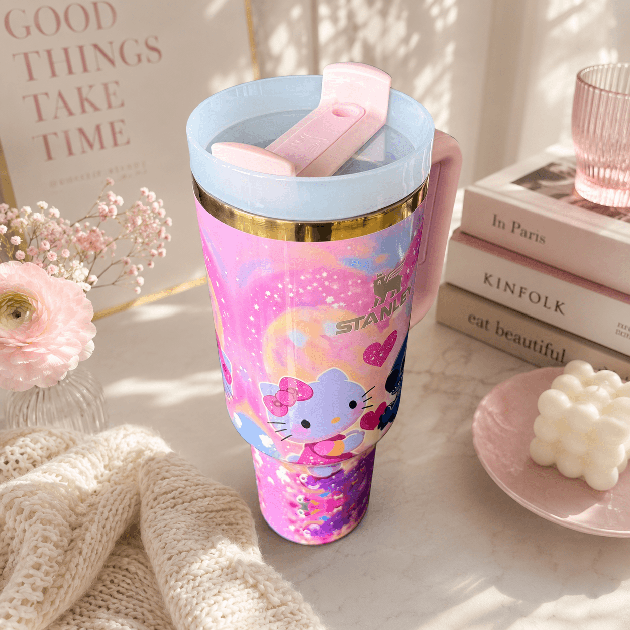 STANLEY tumbler featuring Stitch and Kitty-inspired artwork with pink hearts, pastel colors, insulated construction, large handle, and collectible design.