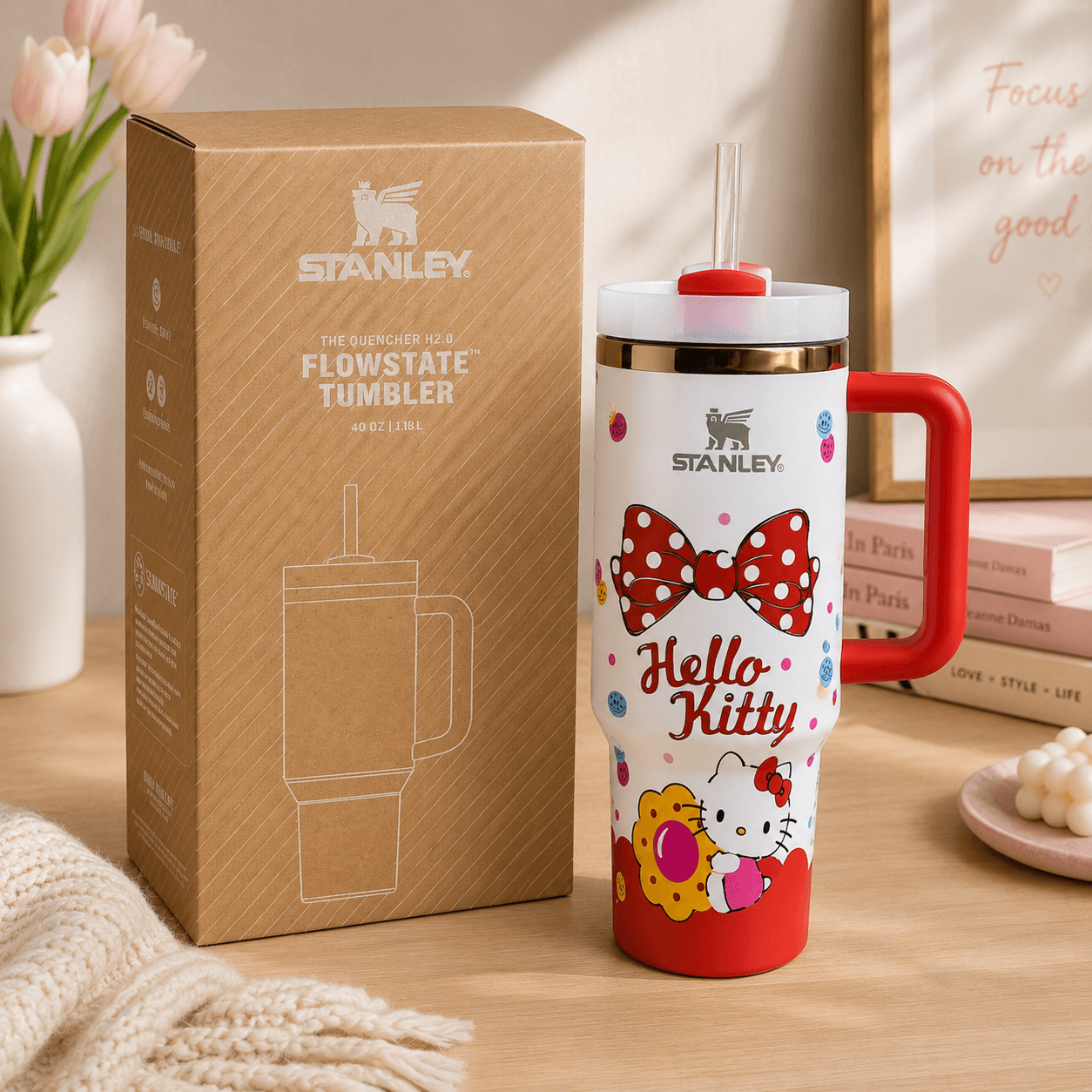 STANLEY Hello Kitty tumbler featuring red bow artwork, colorful accents, reusable straw, insulated construction, gift box, and large-capacity design.