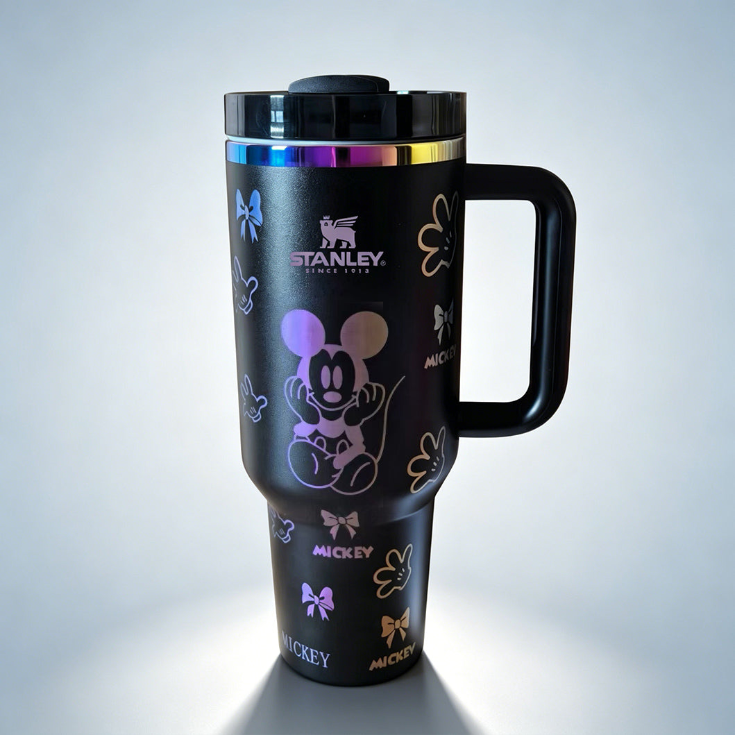 Stanley tumbler with Mickey Mouse design on a gray background