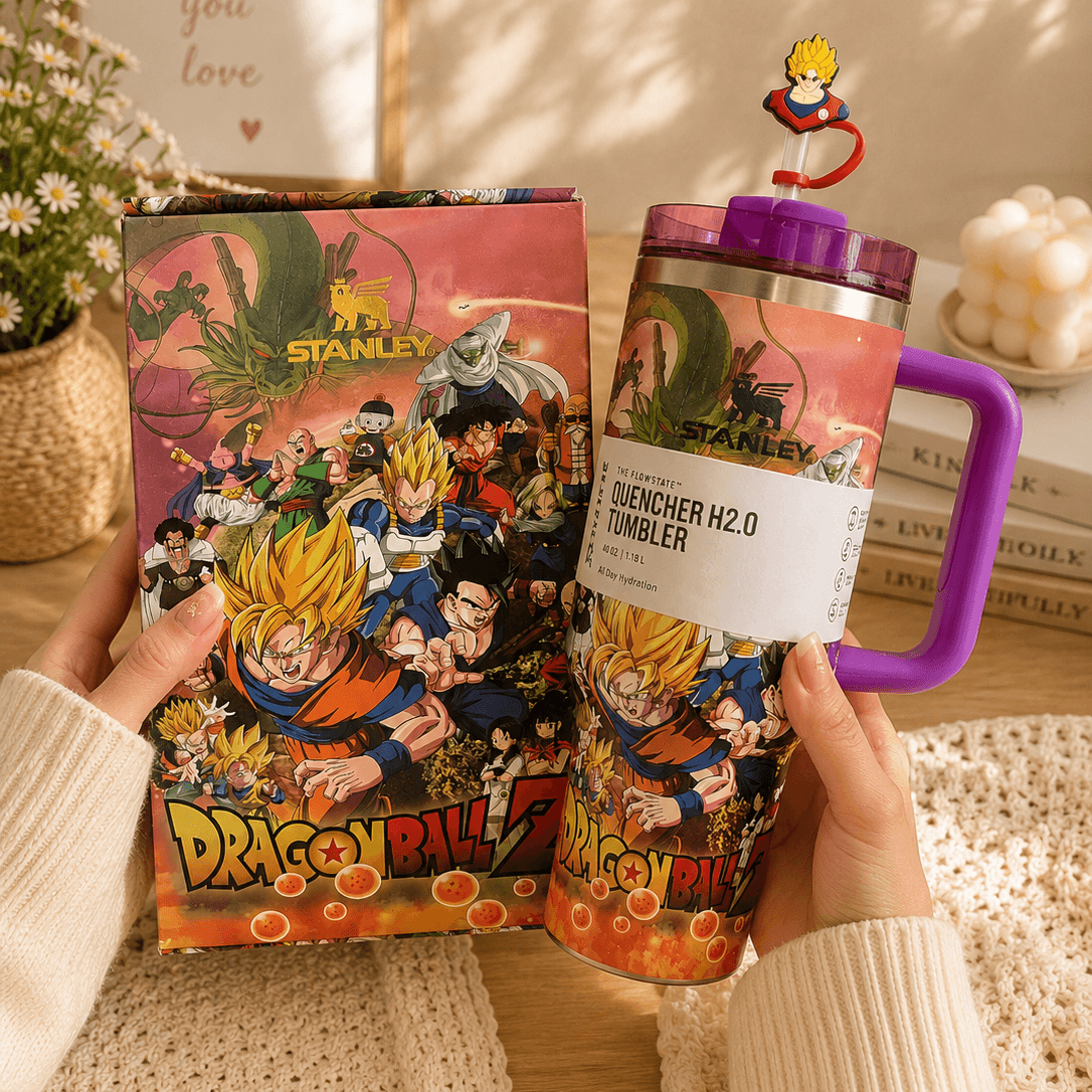 Person holding a Dragon Ball Z-themed Stanley cup with packaging in the background.