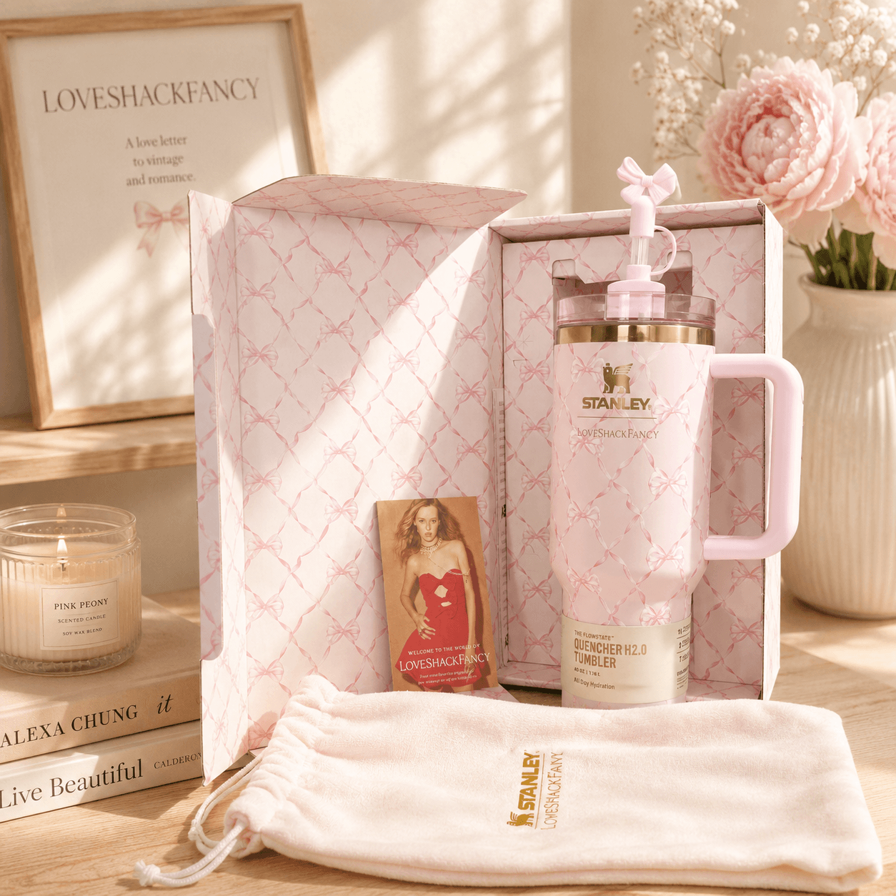 Pink Stanley mug with decorative elements on a wooden surface