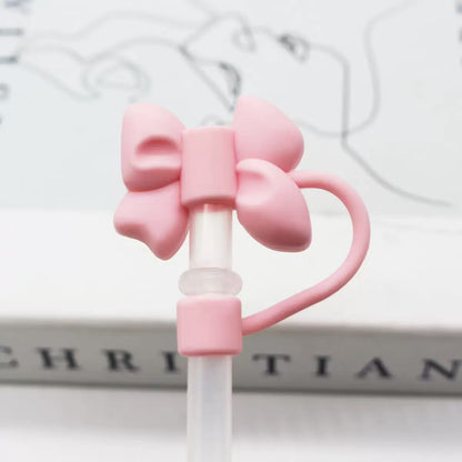 Pink bow-shaped straw holder on a white background