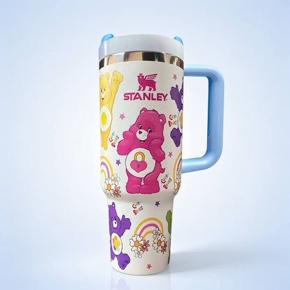 STANLEY Care Bears tumbler featuring colorful bear characters, rainbow accents, floral details, insulated construction, blue handle, and large-capacity design.