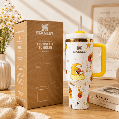 STANLEY Moon Dream tumbler with yellow handle, moon and star illustrations, reusable straw, insulated construction, and matching gift box.