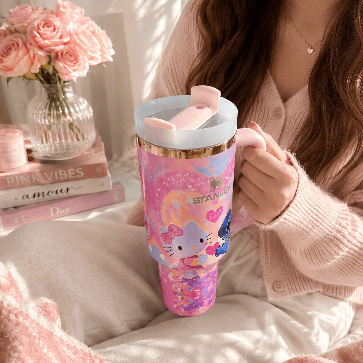 STANLEY tumbler featuring Stitch and Kitty-inspired artwork with pink hearts, pastel colors, insulated construction, large handle, and collectible design.