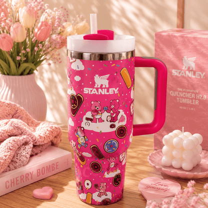 Stanley 40oz insulated tumbler featuring a pink Care Bears-inspired design with donuts, sprinkles, clouds, reusable straw, ergonomic handle, and double-wall vacuum insulation.