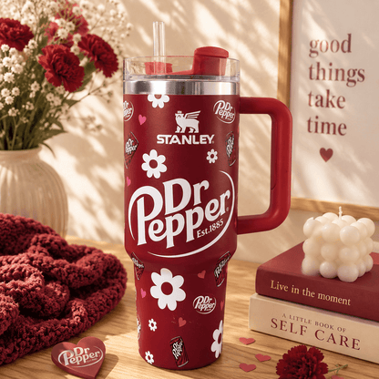 Stanley 40oz insulated tumbler with a Dr Pepper-inspired burgundy design, floral accents, reusable straw, ergonomic handle, and double-wall vacuum insulation.