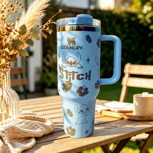 Stanley Tropical Stitch Tumbler with blue tropical-inspired character artwork, floral accents, palm leaf details, ergonomic handle, and insulated large-capacity design.
