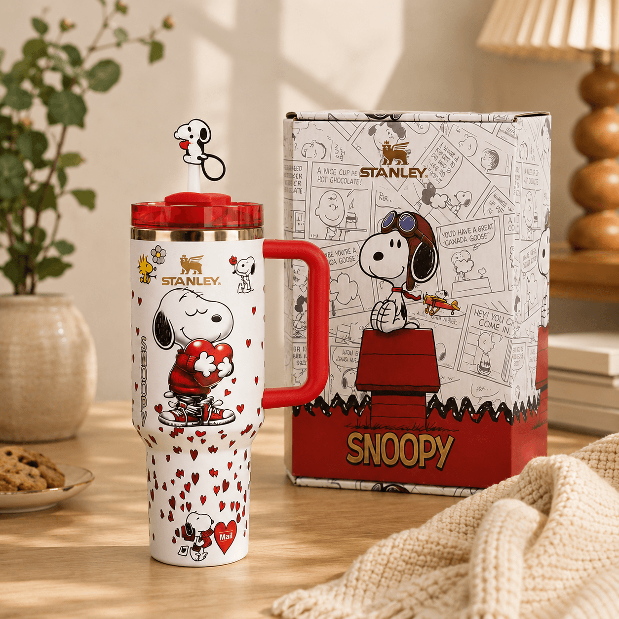 Stanley mug with Snoopy design on a table with a matching box in the background.