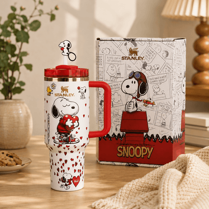 Stanley mug with Snoopy design on a table with a matching box in the background.