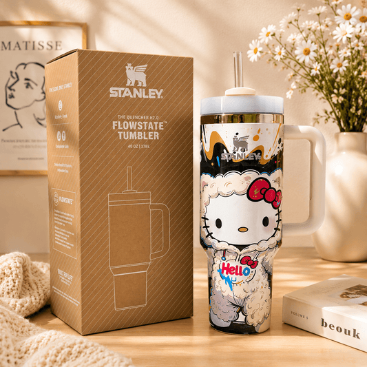 Stanley tumbler with Hello Kitty design next to its packaging on a wooden surface.