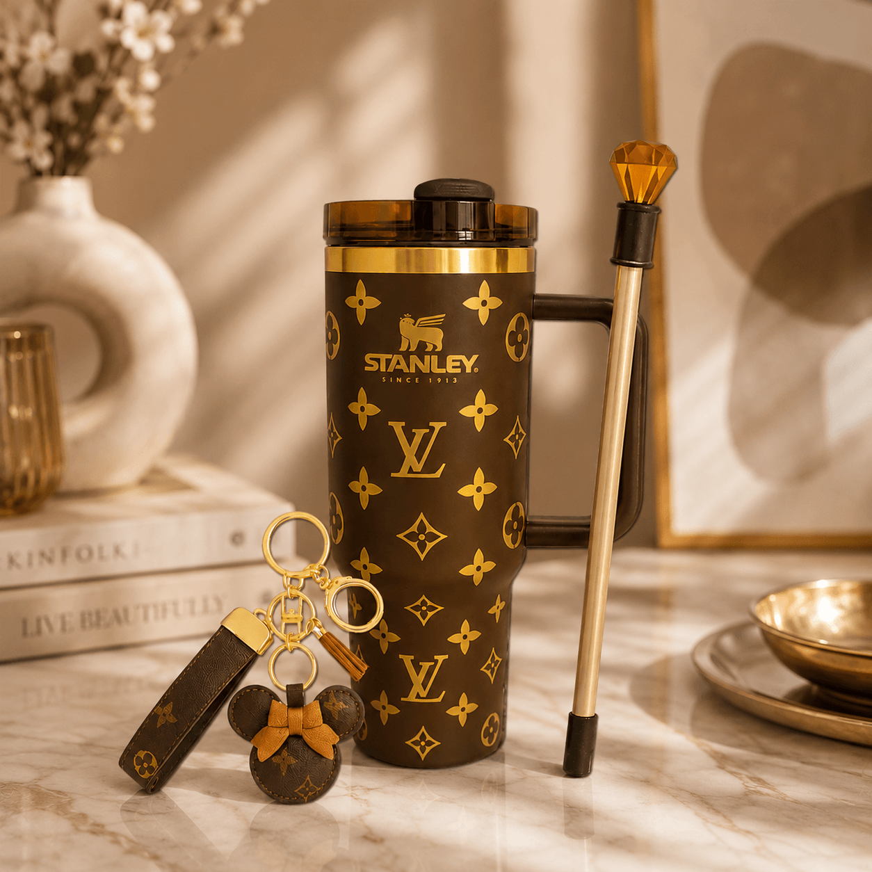Stanley tumbler with Louis Vuitton pattern on a marble surface