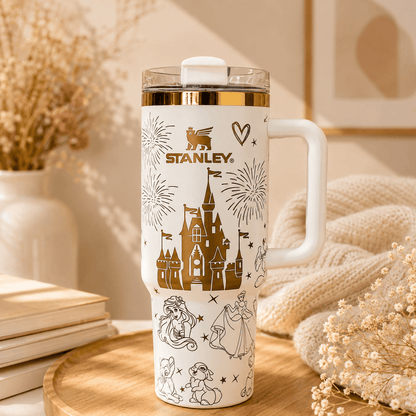 Stanley tumbler with princess design on a wooden surface with decorative elements.