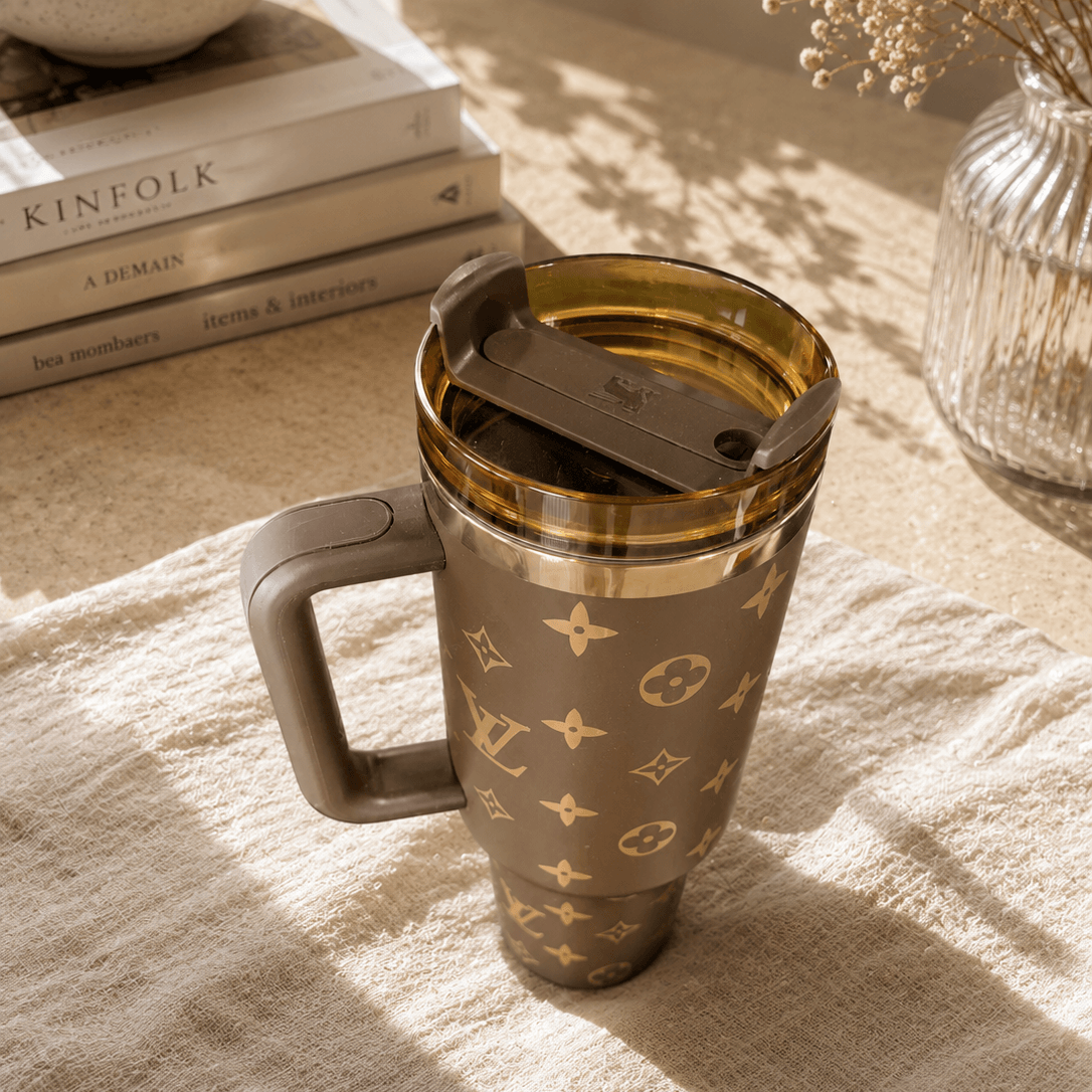 Travel mug with brand logo on a textured surface