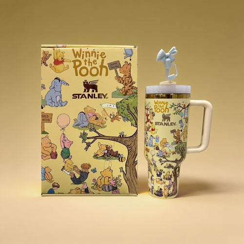 Winnie the Pooh-themed Stanley mug and notebook on a beige background