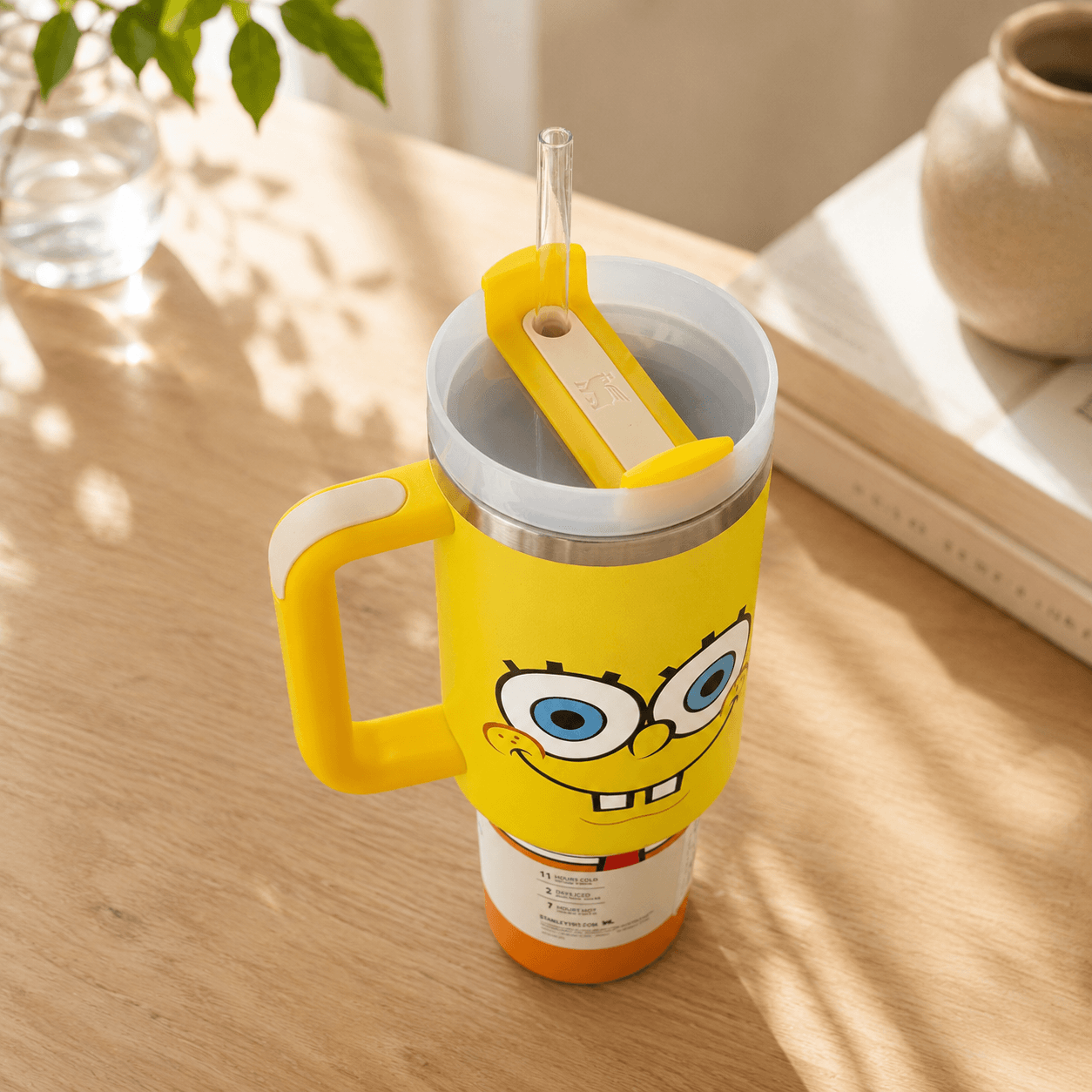 Yellow tumbler with a cartoon character on a wooden surface